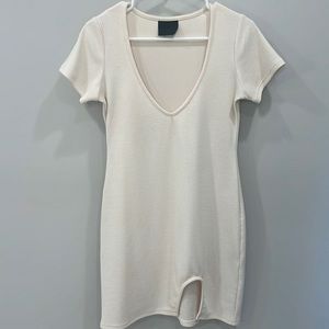 Ribbed short sleeved v neck cream dress with small slit